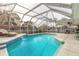 Inviting screened-in pool area with a refreshing pool, comfortable lounge chairs, and an ideal space for relaxation at 559 Eagle Dr, Daytona Beach, FL 32117