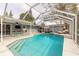 Relaxing screened pool area with lounge chair and outdoor dining at 559 Eagle Dr, Daytona Beach, FL 32117