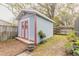 Charming backyard shed with a red door, perfect for storage or a creative workspace, nestled in a tranquil setting at 559 Eagle Dr, Daytona Beach, FL 32117