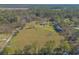 Aerial view of property showcasing home, outbuildings, and land at 601 Rasley Rd, New Smyrna Beach, FL 32168