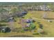 Aerial view of a home with a pool and deck on a large property with mature trees at 601 Rasley Rd, New Smyrna Beach, FL 32168