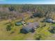 Aerial view of a single story home with a pool and deck, surrounded by lush green landscape at 601 Rasley Rd, New Smyrna Beach, FL 32168