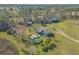 Aerial view of a home with a pool and deck, situated on a spacious lot with trees and open space at 601 Rasley Rd, New Smyrna Beach, FL 32168