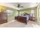 Main bedroom with ceiling fan and large windows at 601 Rasley Rd, New Smyrna Beach, FL 32168