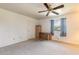 Bright bedroom with carpet flooring, ceiling fan, and window coverings at 601 Rasley Rd, New Smyrna Beach, FL 32168