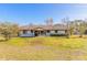 Single-story home with brown trim and a spacious lawn at 601 Rasley Rd, New Smyrna Beach, FL 32168