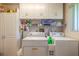 Laundry room with washer, dryer, and ample storage cabinets at 601 Rasley Rd, New Smyrna Beach, FL 32168