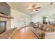 Living room with stone fireplace, hardwood floors, and patio access at 601 Rasley Rd, New Smyrna Beach, FL 32168