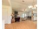 Open living area with stone fireplace and wood floors at 601 Rasley Rd, New Smyrna Beach, FL 32168