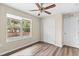 Bright bedroom with double windows, ceiling fan, and laminate wood floors at 639 Florida Ave, Daytona Beach, FL 32117