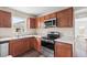 Kitchen with wood cabinets, granite countertops, and stainless steel appliances at 639 Florida Ave, Daytona Beach, FL 32117
