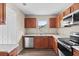 Kitchen with wood cabinets, granite countertops, and stainless steel appliances at 639 Florida Ave, Daytona Beach, FL 32117