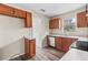 Kitchen with wood cabinets, granite countertops, and stainless steel appliances at 639 Florida Ave, Daytona Beach, FL 32117