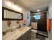 Modern bathroom features a marble countertop, updated fixtures, and a sleek glass-enclosed shower at 744 Baywood Ln, South Daytona, FL 32119