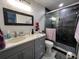 Updated bathroom with walk-in shower, gray vanity, and marble countertop at 744 Baywood Ln, South Daytona, FL 32119