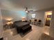 Inviting bedroom with wood-look tile floors, neutral colors, and ceiling fan at 744 Baywood Ln, South Daytona, FL 32119