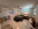 Spacious bedroom with modern ceiling fan and wood-look tile flooring at 744 Baywood Ln, South Daytona, FL 32119