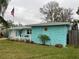 Charming home featuring a colorful exterior and well-manicured lawn at 744 Baywood Ln, South Daytona, FL 32119
