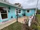 Inviting front porch with seating area and colorful flowers at 744 Baywood Ln, South Daytona, FL 32119