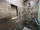 Walk-in shower features gray marble tile, handheld sprayer, and grab bars at 744 Baywood Ln, South Daytona, FL 32119