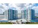 Aerial view of waterfront property with tennis courts and pool at 925 N Halifax Ave # 1001, Daytona Beach, FL 32118