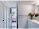 Bright bathroom with white vanity and view of bedroom at 925 N Halifax Ave # 1001, Daytona Beach, FL 32118