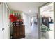 Hallway view with wood cabinet, artwork, and view into dining area at 925 N Halifax Ave # 1001, Daytona Beach, FL 32118