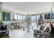 Spacious living room with floral sofas, large windows, and city view at 925 N Halifax Ave # 1001, Daytona Beach, FL 32118