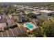 Aerial view of condo complex with pool and tennis court at 100 E Kentucky Ave # K106, Deland, FL 32724