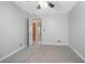 Bedroom with gray walls, gray carpet and ceiling fan at 100 E Kentucky Ave # K106, Deland, FL 32724