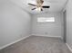 Bedroom with gray walls, gray carpet, ceiling fan and window at 100 E Kentucky Ave # K106, Deland, FL 32724