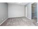 Bright bedroom with grey carpet and double door closet at 100 E Kentucky Ave # K106, Deland, FL 32724