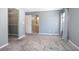 Bedroom with grey carpet, closet, and ensuite bathroom at 100 E Kentucky Ave # K106, Deland, FL 32724