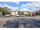 Building exterior with ample parking spaces at 100 E Kentucky Ave # K106, Deland, FL 32724