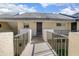 Exterior view of condo building showcasing walkway access to unit at 100 E Kentucky Ave # K106, Deland, FL 32724