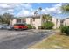 Building exterior with parking spaces in front at 100 E Kentucky Ave # K106, Deland, FL 32724