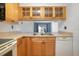 Kitchen boasts light wood cabinets and a view to the living room at 100 E Kentucky Ave # K106, Deland, FL 32724