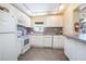 Well-equipped community kitchen with white cabinets at 100 E Kentucky Ave # K106, Deland, FL 32724