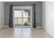 Living room features gray walls, laminate flooring and sliding glass doors at 100 E Kentucky Ave # K106, Deland, FL 32724