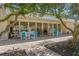 Relaxing community patio shaded by lush trees at 100 E Kentucky Ave # K106, Deland, FL 32724