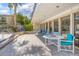 Community patio with tables and chairs near pool at 100 E Kentucky Ave # K106, Deland, FL 32724