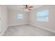 Spacious bedroom with ceiling fan and large window at 1006 Martin St, New Smyrna Beach, FL 32168