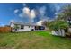 Spacious backyard with screened porch, shed, and fenced yard at 1036 Tompkins Dr, Port Orange, FL 32129