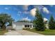 Charming single-story home with a well-maintained lawn and driveway at 1036 Tompkins Dr, Port Orange, FL 32129