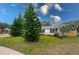 Side view of the house, highlighting the landscaping and lawn at 1036 Tompkins Dr, Port Orange, FL 32129