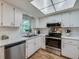 Bright kitchen with stainless steel appliances and white cabinets at 1036 Tompkins Dr, Port Orange, FL 32129