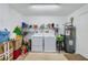 Laundry room with washer, dryer, and storage shelves at 1036 Tompkins Dr, Port Orange, FL 32129