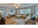Living room boasts an L-shaped sofa, wood flooring, and ample natural light at 1036 Tompkins Dr, Port Orange, FL 32129
