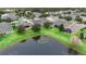 Community overview with lake and houses at 1105 Gardenshire Ln, Deland, FL 32724