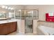 Large bathroom with a walk-in shower and corner soaking tub at 1105 Gardenshire Ln, Deland, FL 32724